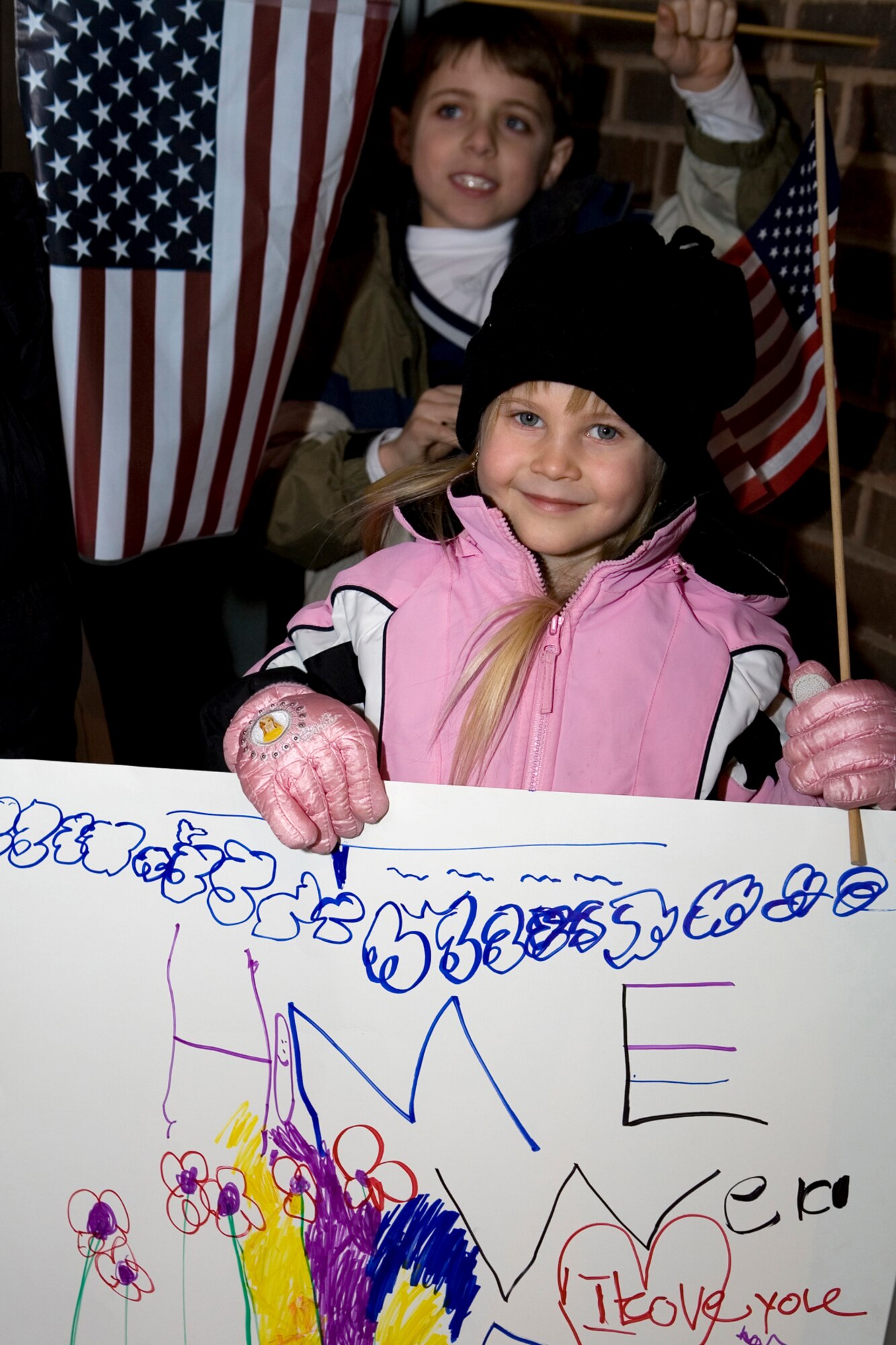 GRISSOM AIR RESERVE BASE, Ind. -- Displaying flags and hand-made banners, friends and family gather in the foyer of the 434th Security Forces Squadron building awaiting the arrival of four Airmen returning to Grissom on Jan. 13. The four 434th SFS members were deployed to Kirkuk AB, Iraq, where they provided air base ground defense support to forces stationed there. (U.S. Air Force photo/Senior Airman Omar Delacruz)