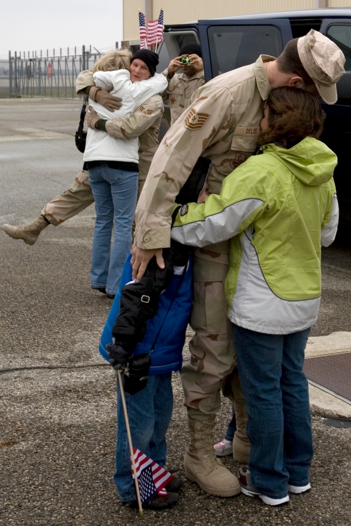 GRISSOM AIR RESERVE BASE, Ind. -- Tech. Sgt. Robert DeLee of Plymouth, Ind., shares a tender moment with his family upon his return home following a six-month deployment to Iraq Jan. 13. Sergeant DeLee was among four 434th Security Forces Squadron members  that provided air base ground defense personnel stationed at Kirkuk, Air Base. (U.S. Air Force photo/SrA. Omar Delacruz)