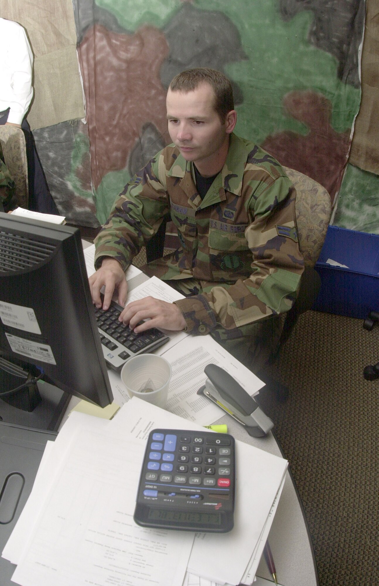 Airman 1st Class David Graham crunches some numbers and reviews some figures for the 2007 End-of-Year closeout inside the 17 CPTS conferenece room Sept. 28, 2007. Airman Graham was selected by Air Education and Training Command as the Financial Management Airman of the Year for 2007. (U.S. Air Force photo by Senior Airman Luis Loza Gutierrez.)