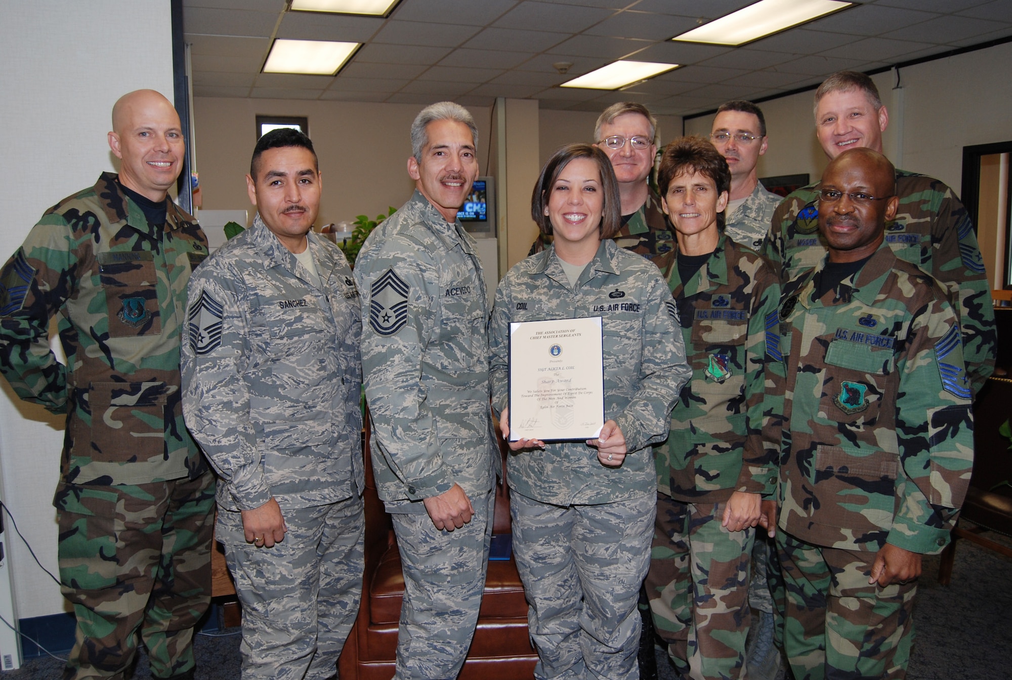 Staff Sgt. Alicia Coil, 53d Wing staff, stands with members of Eglin Air Force Base's Chief's Group after being chosen for the Sharp Troop Award January 14.  Air Force photo by Capt. Carrie Kessler.