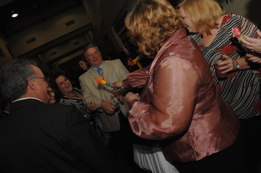 MOODY AIR FORCE BASE, Ga. -- Members of Team Moody hand out noise makers to cheer on friends and co workers before the start of the Moody Air Force Base Annual Awards Jan 12. The evening honored the wing's top military and civilian performers in 10 different categories. (U.S. Air Force photo by Airman 1st Class Gina Chiaverotti)

