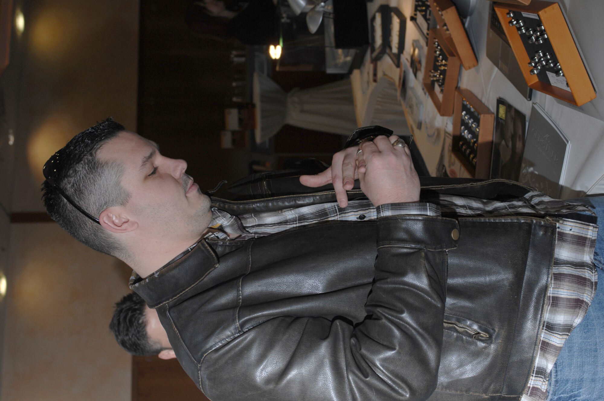 SPANGDAHLEM AIR BASE, Germany – Senior Airman Matthew Bright, 52nd Fighter Wing, tries on rings at a wedding fair hosted by Club Eifel Jan. 13, 2008.  Many local vendors were present to assist members of the Eifel community with their wedding plans. (U.S. Air Force photo/Staff Sgt. Heather M. Norris)