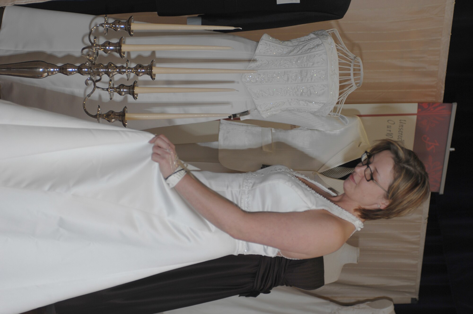 SPANGDAHLEM AIR BASE, Germany -- Sheila Springwald, fiancée of Senior Airman Matthew Bright, 52nd Fighter Wing, admires a dress at a wedding fair hosted in Club Eifel Jan. 13, 2008. Many local vendors were present to assist members of the Eifel community with their wedding plans. (U.S. Air Force photo/Staff Sgt. Heather M. Norris)