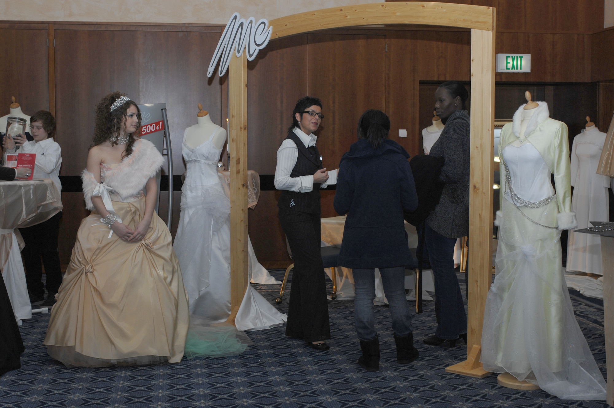 SPANGDAHLEM AIR BASE, Germany – A wedding dress consultant explains how all of their gowns are custom designed as members of Spangdahlem Air Base spend the day planning their “big day” at a wedding fair here Jan. 13, 2008. (U.S. Air Force photo/Staff Sgt. Heather M. Norris)