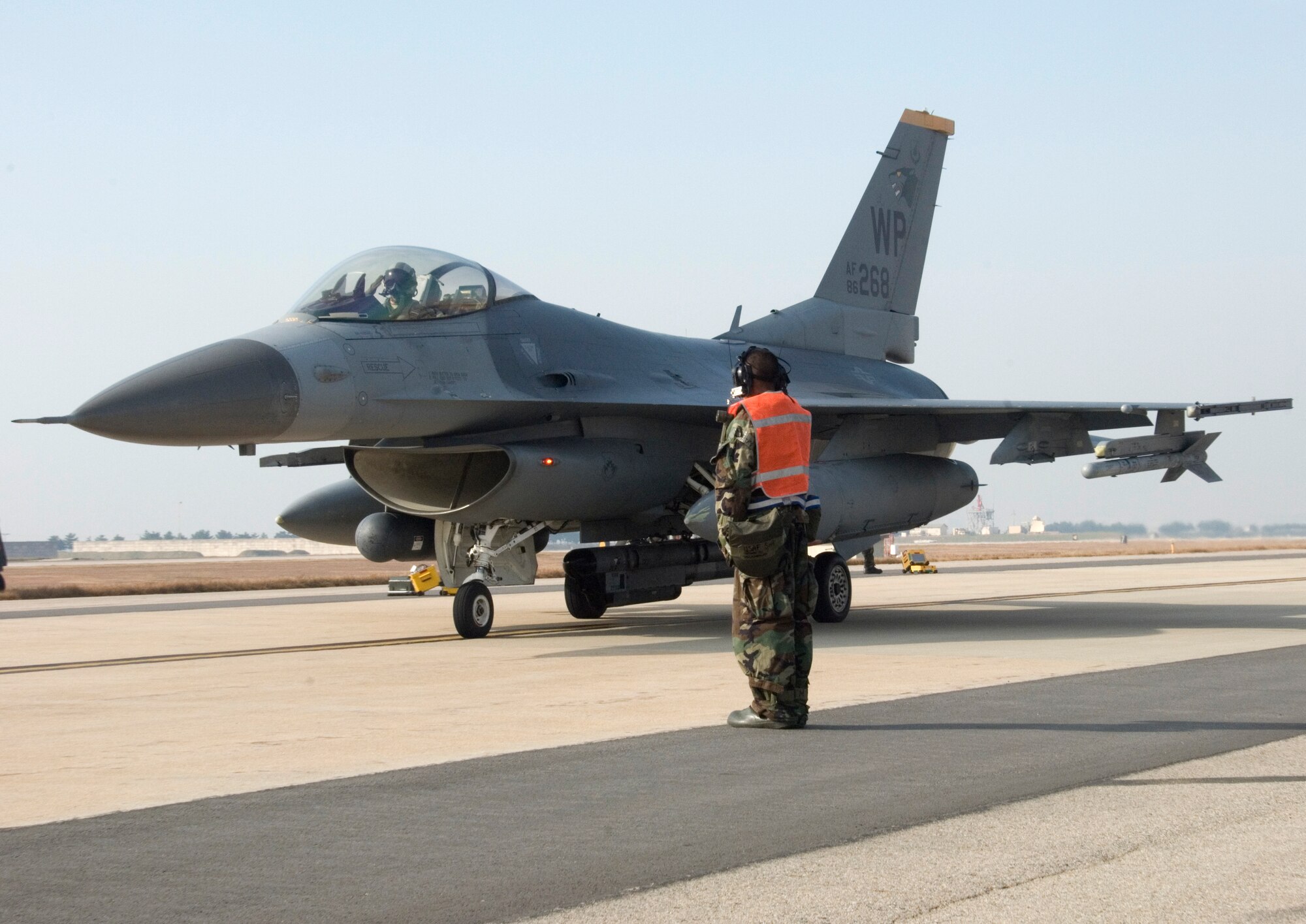 KUNSAN AIR BASE, South Korea -- Maintainers send off a pilot after his safety checks during a Peninsula-wide Operational Readiness Exercise (PENORE) here Jan. 14.  The PENORE is used to train Air Force members and ensure they are ready to perform their war time mission, should the need arise.  (U.S. Air Force Photo/Senior Airman Steven R. Doty)