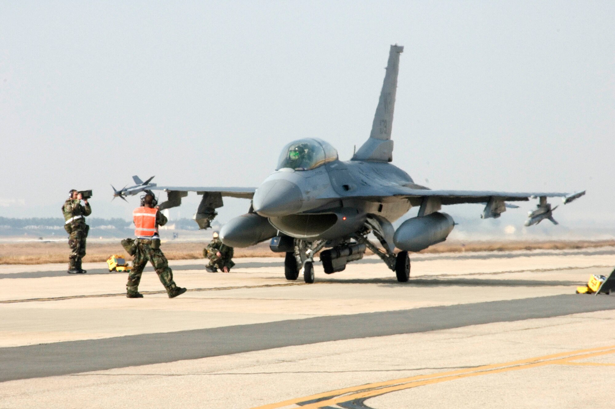 KUNSAN AIR BASE, South Korea -- Maintainers conduct final pre-flight safety checks during a Peninsula-wide Operational Readiness Exercise (PENORE) here Jan. 14.  The PENORE is used to train Air Force members and ensure they are ready to perform their war time mission, should the need arise.  (U.S. Air Force Photo/Senior Airman Steven R. Doty)