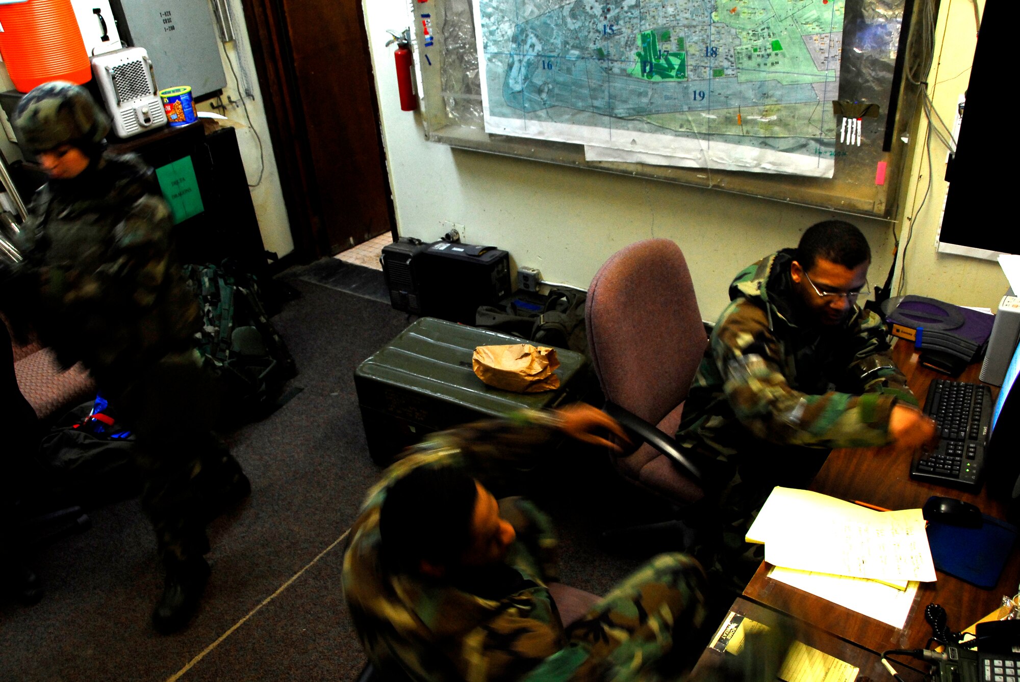 KUNSAN AIR BASE, South Korea -- 8th Security Forces Squadron personnel conduct radio checks and guard post assignments at Delta Section Command Post during a Peninsula Operational Readiness Exercise (PENORE) here Jan 14.  Kunsan is currently participating in a PENORE to test its ability of defending the base, accepting follow-on forces and taking the fight north.  (U.S. Air Force photo / TSgt Quinton T. Burris)