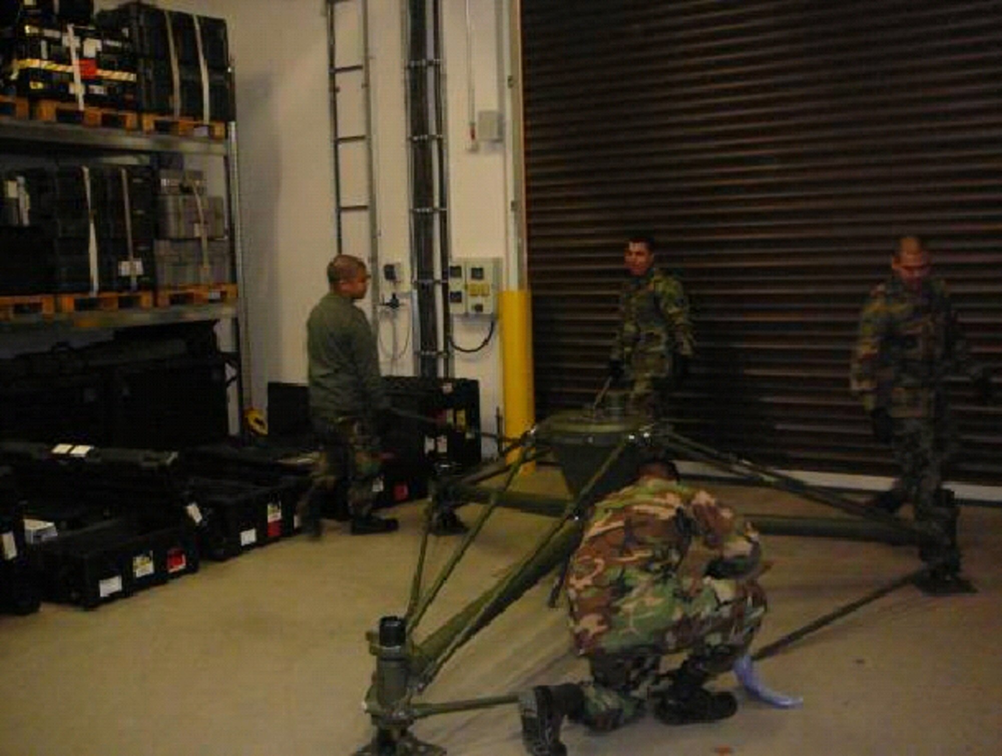 Staff sergeants Laramie Cosek, William Arcilla and David Zabell, and Airman 1st Class Harry Sinner, 1st Combat Communications Squadron satellite communications technicians, prepare their quad band dual hub satellite antenna for another deployment. (Courtesy photo)