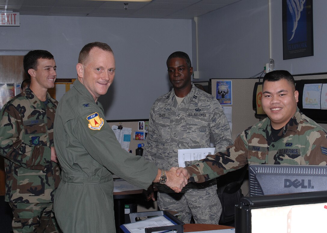 Col. Gregory Cain, 36th Wing vice commander, introduces himself to Senior Airman Tuan Pham, 36th Comptroller Squadron Financial Services technician, during his "meet and greet" at the 36th CPTS Jan 10. Col Cain arrived on island in December 2007. (U.S. Air Force photo/Senior Airman Sonya Padilla)