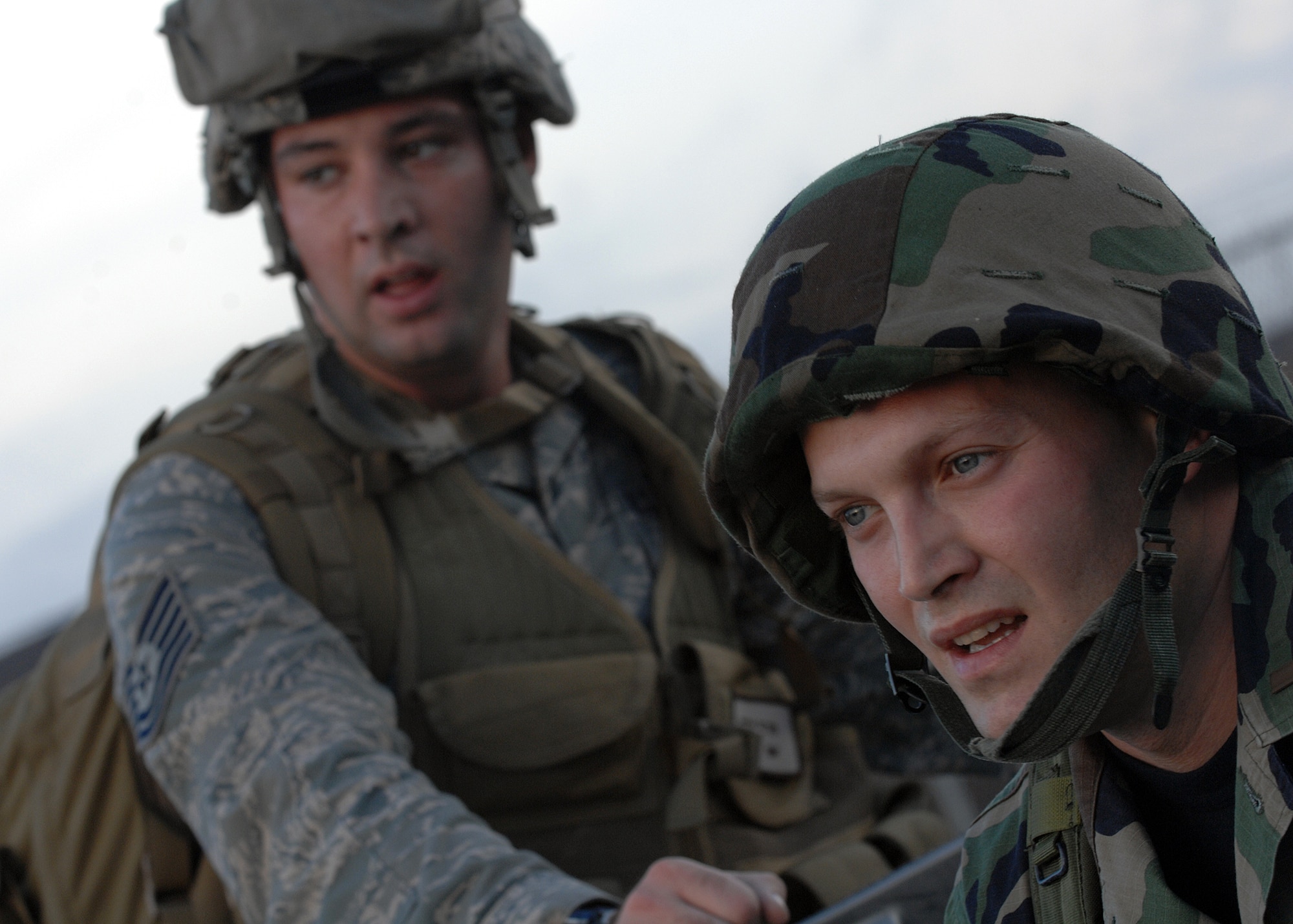 MOODY AIR FORCE BASE, Ga. -- Tech Sgt. Joseph S. Ritter and 2nd Lt. Arnold F. Aviles, 23rd Civil Engineering Squadron, take a minute to relax after a five mile rucksack march here Jan. 11. The 23rd CES held a readiness challenge including the rucksack march, litter carrying race, Airman's Manual knowledge test and other events. (U.S. Air Force photo by Airman 1st Class Brittany Barker)