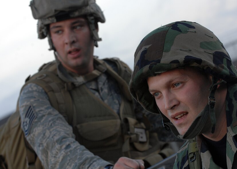 MOODY AIR FORCE BASE, Ga. -- Tech Sgt. Joseph S. Ritter and 2nd Lt. Arnold F. Aviles, 23rd Civil Engineering Squadron, take a minute to relax after a five mile rucksack march here Jan. 11. The 23rd CES held a readiness challenge including the rucksack march, litter carrying race, Airman's Manual knowledge test and other events. (U.S. Air Force photo by Airman 1st Class Brittany Barker)