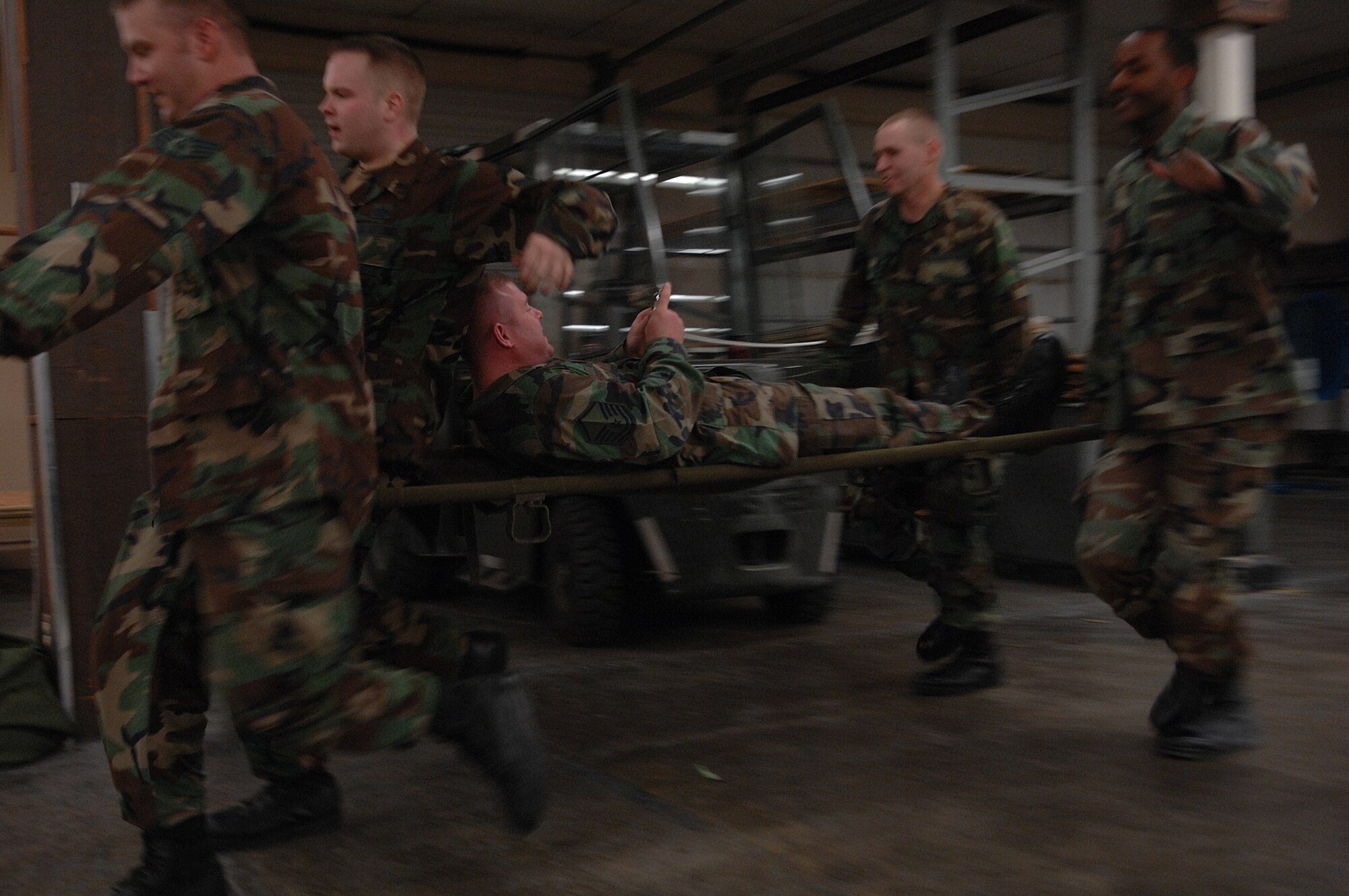 MOODY AIR FORCE BASE, Ga. -- Members of the 23rd Civil Engineering Squadron carry an evaluator on a litter during a readiness challenge Jan. 11 here. The 23rd CES readiness challenge began with a rucksack march and later dispersed into smaller events. (U.S. Air Force photo by Airman 1st Class Brittany Barker)