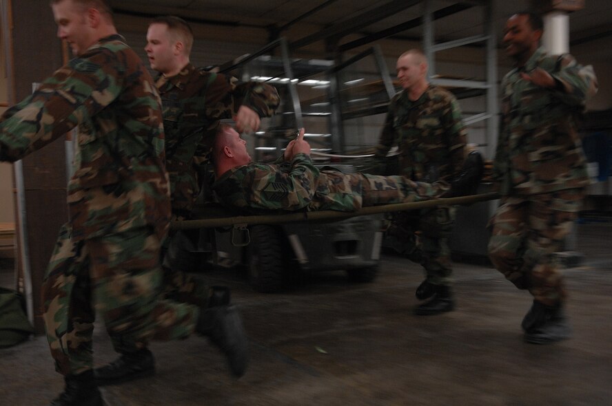 MOODY AIR FORCE BASE, Ga. -- Members of the 23rd Civil Engineering Squadron carry an evaluator on a litter during a readiness challenge Jan. 11 here. The 23rd CES readiness challenge began with a rucksack march and later dispersed into smaller events. (U.S. Air Force photo by Airman 1st Class Brittany Barker)