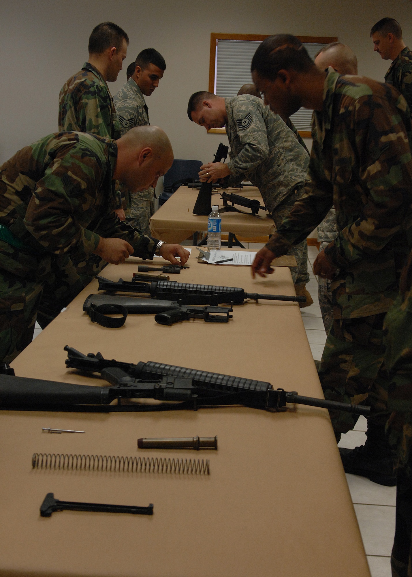 MOODY AIR FORCE BASE, Ga. -- Members of the 23rd Civil Engineering Squadron assemble M-16s during a readiness challenge Jan. 11 here. The 23rd CES readiness challenge began with a rucksack march and later dispersed into smaller events including fire hose drag, chemical warfare gear relay and a litter carry race. (U.S. Air Force photo by Airman 1st Class Brittany Barker)
