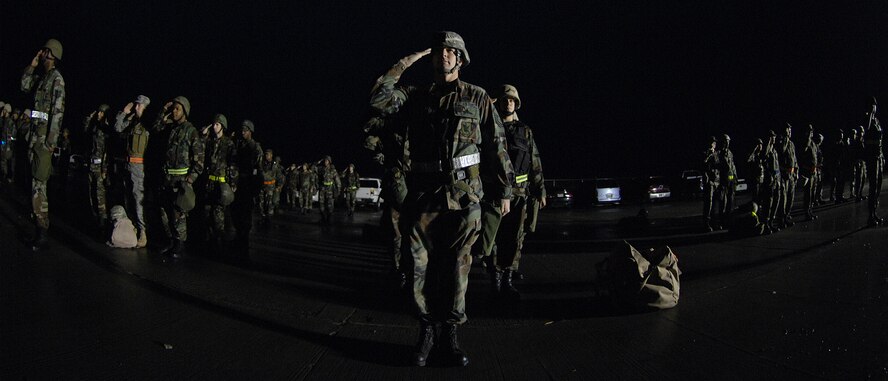 MOODY AIR FORCE BASE, Ga. -- Members of the 23rd Civil Engineering Squadron salute in formation during morning Reveille here Jan. 11. The 23rd CES held a readiness challenge that began with a sunrise rucksack march. (U.S. Air Force photo by Airman 1st Class Brittany Barker)
