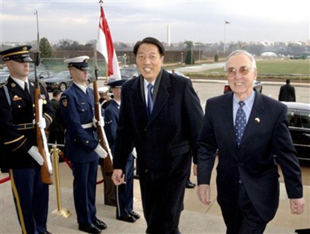 Deputy Secretary of Defense Gordon England (right) escorts Singapore's Minister of Defense Teo Chee Hean (left) through an honor cordon and into the Pentagon on Jan. 14, 2008.  England and Teo will meet to discuss a broad range of bilateral security issues. Teo will later meet with Secretary of Defense Robert M. Gates at a working lunch.  