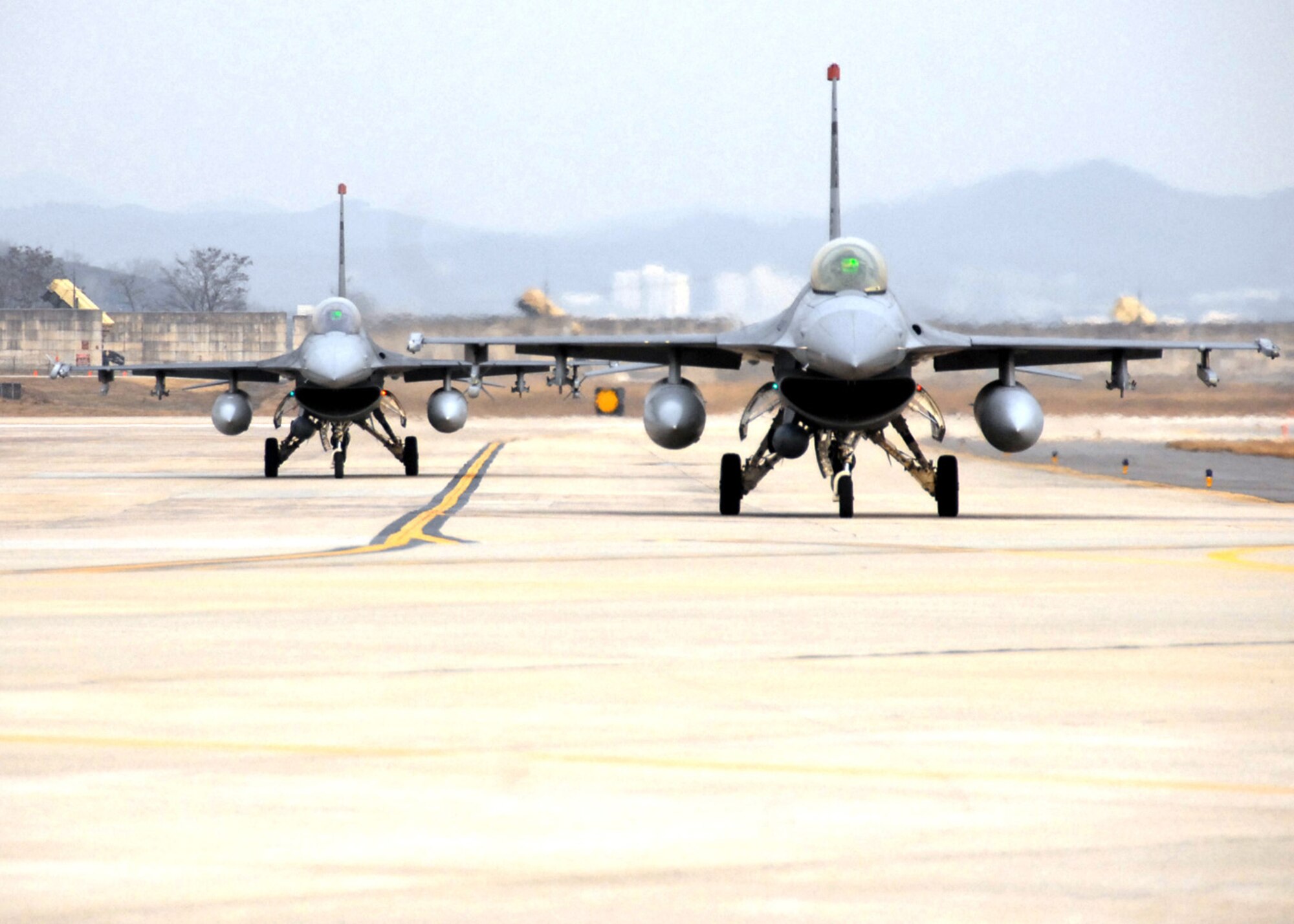 OSAN AIR BASE, Republic of Korea --Two F-16 Fighting Falcons from the 36th Fighter Squadron taxi prior to taking off during a peninsula-wide exercise on Osan Air Base.  The operational readiness exercise tests Team Osan's ability to execute combat operations, receive follow-on forces and defend the base from attack.  (U.S. Air Force Photo by Staff Sgt Ronnie Hill)