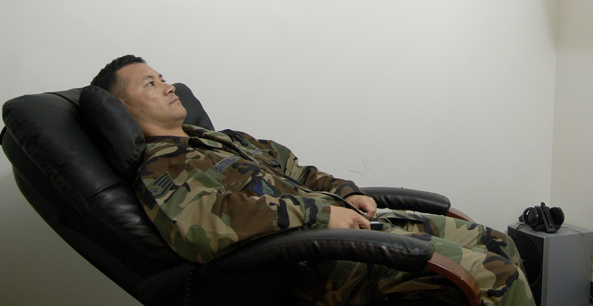 Staff Sgt. Max Pontenilla, 36th Services Squadron Fitness Program NCOIC, demonstrates the massage chair in the Relaxation Room at Andersen Air Force Base Health and Wellness Center. The HAWC is offering a variety classes in observance of "Healthy Weight Month." (U.S. Air Force photo/Master Sgt. Lisa Zunzanyika)                    