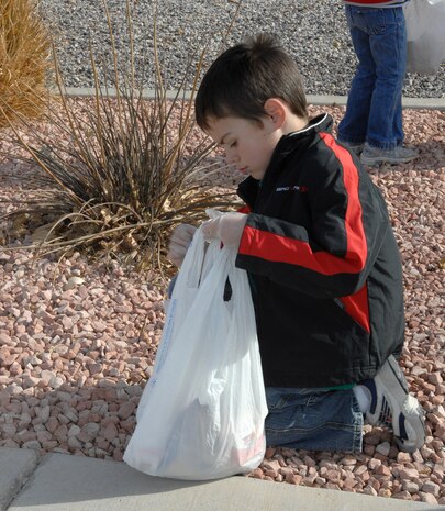 Calab Kiser, son of Chaplin Capt. Scott Kiser, 99th Air Base Wing, cleans up Nellis as part of a Approved Workmen Are Not Ashamed (AWANA) volunteer event dedicated to improving Nellis’ community appearance, Jan. 12. AWANA's is a religious youth group for children between ages two to 18, whose goal is to raise spiritual awareness among its members and seek out volunteer opportunities. (U.S. Air Force photo by Senior Airman Nadine Y. Barclay)