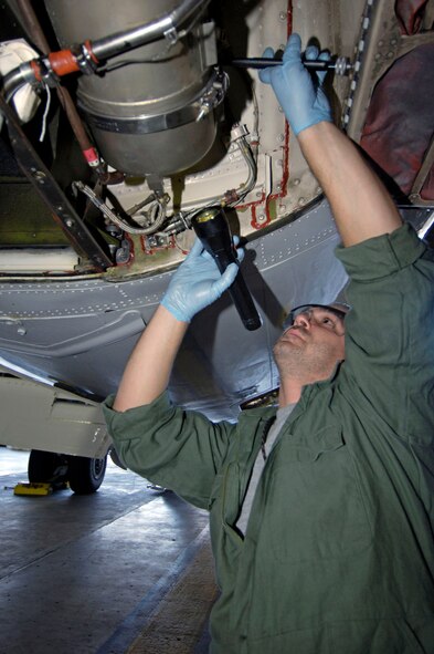 James Mattingly, an aerospace propulsion craftsman from the 932nd Maintenance Group, 932nd Airlift Wing, re-installs a combustion chamber on an auxiliary power unit on a C-9C Skytrain aircraft in hangar one, Scott AFB, Ill.  
U.S. Air Force photo/Tech. Sgt. Tony R. Tolley
