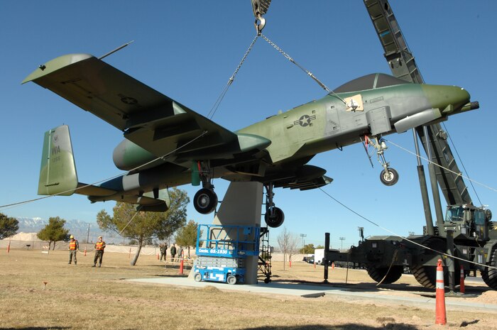 A-10 “Warthog” crew chiefs and maintenance personnel assigned to the 57th Equipment Maintenance and 99th Civil Engineer squadrons, prepare to position the aircraft on a static display at Freedom Park here, Jan. 14. Previously a static display at Naval Air Station New Orleans with the 706th Fighter Squadron, work to bring the A-10 to Nellis began more than a year ago. Airmen from the 57th EMS refurbished the aircraft at the behest of 99th Air Base Wing installation commander, Col. Michael Bartley. The aircraft is on loan from the National Museum of the United States Air Force. (U.S. Air Force photo by Senior Airman Nadine Y. Barclay)
