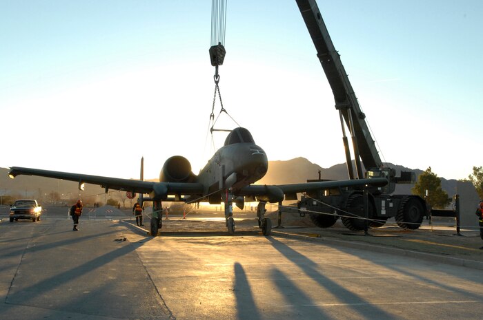 A-10 “Warthog” crew chiefs and maintenance personnel assigned to the 57th Equipment Maintenance and 99th Civil Engineer squadrons, prepare to position the aircraft on a static display at Freedom Park here, Jan. 14. Previously a static display at Naval Air Station New Orleans with the 706th Fighter Squadron, work to bring the A-10 to Nellis began more than a year ago. Airmen from the 57th EMS refurbished the aircraft at the behest of 99th Air Base Wing installation commander, Col. Michael Bartley. The aircraft is on loan from the National Museum of the United States Air Force. (U.S. Air Force photo by Senior Airman Nadine Y. Barclay)