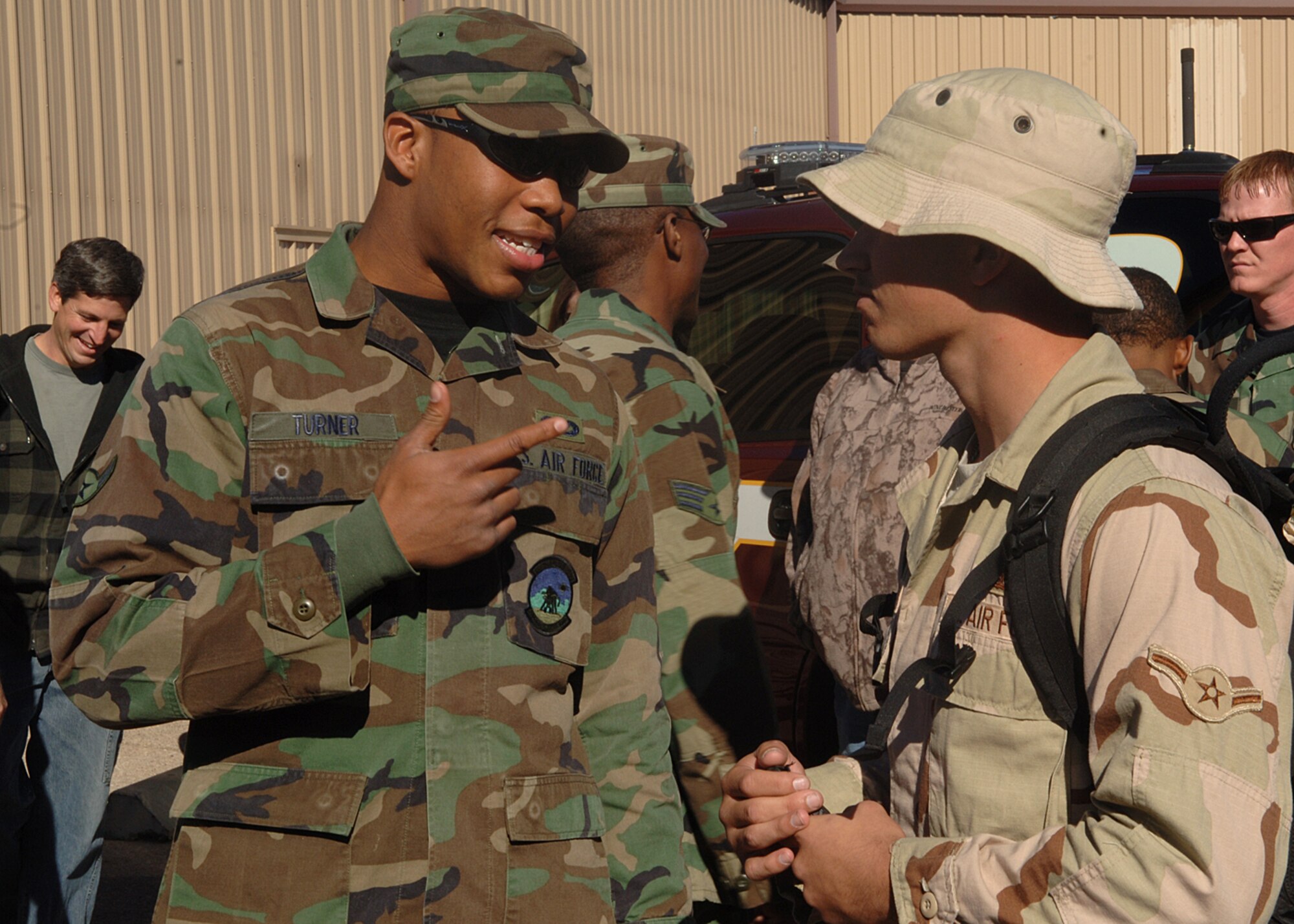 Airman Richard Turner and Airman Jesse Hubbard of the 49th Civil Engineer Squadron catch up on old times, Jan. 10, 2008, Holloman Air Force Base, NM. Amn Hubbard was one of the 45 Civil Engineer Squadron members returning home from a four month deployment to Al-Dhafra. (U.S. Air Force photo/Airman 1st Class John D. Strong II)  