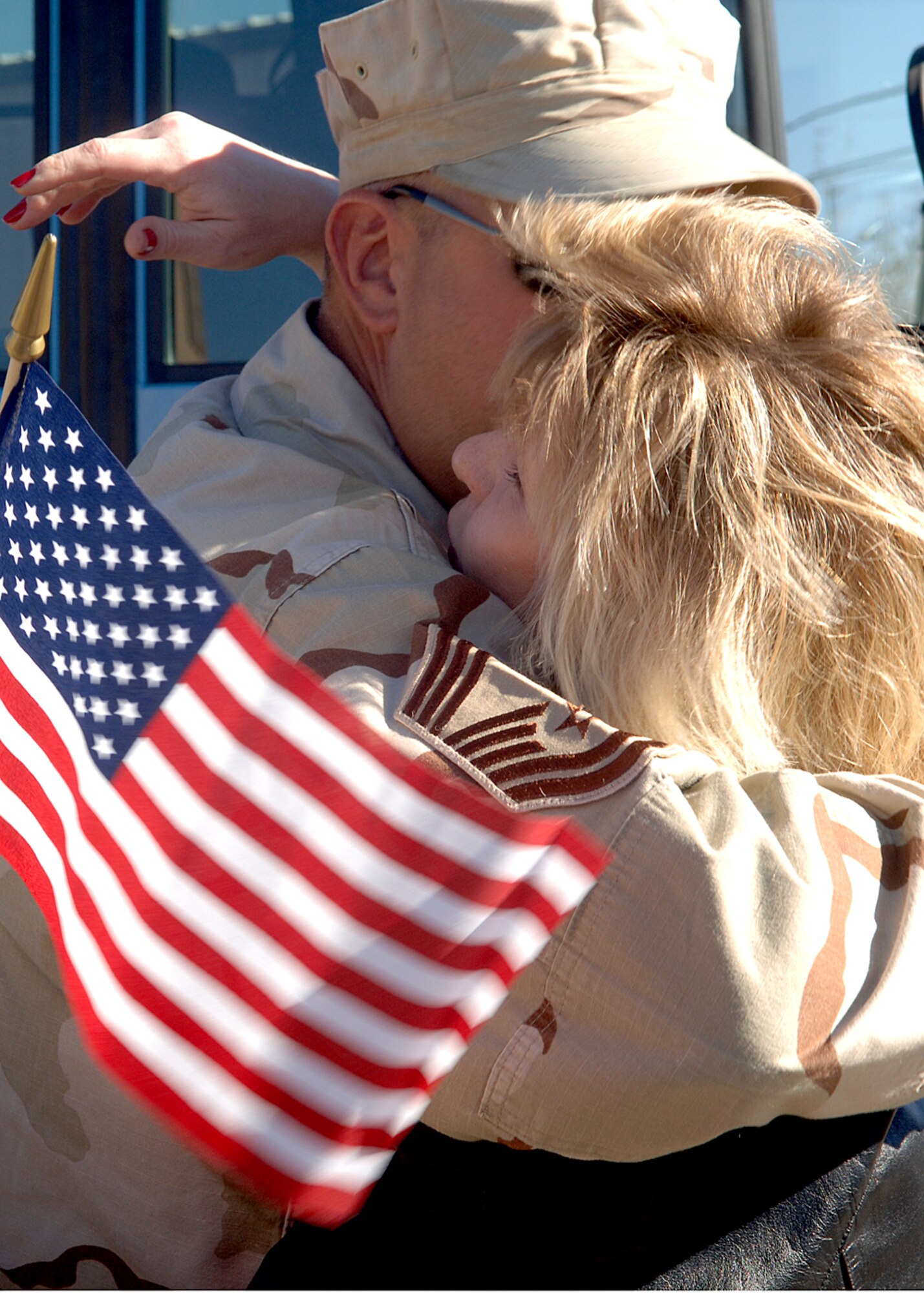 Chief Master Sgt. John Gibson II, 49th Civil Engineer Squadron holds his wife Connie Gibson as he returns to Holloman Air Force Base, N.M Jan. 10, 2008. Chief Master Sgt. Gibson was one of the 45 Civil Engineer Squadron members returning home from a four month deployment to Al-Dhafra. (U.S. Air Force photo/Airman 1st Class John D. Strong II)