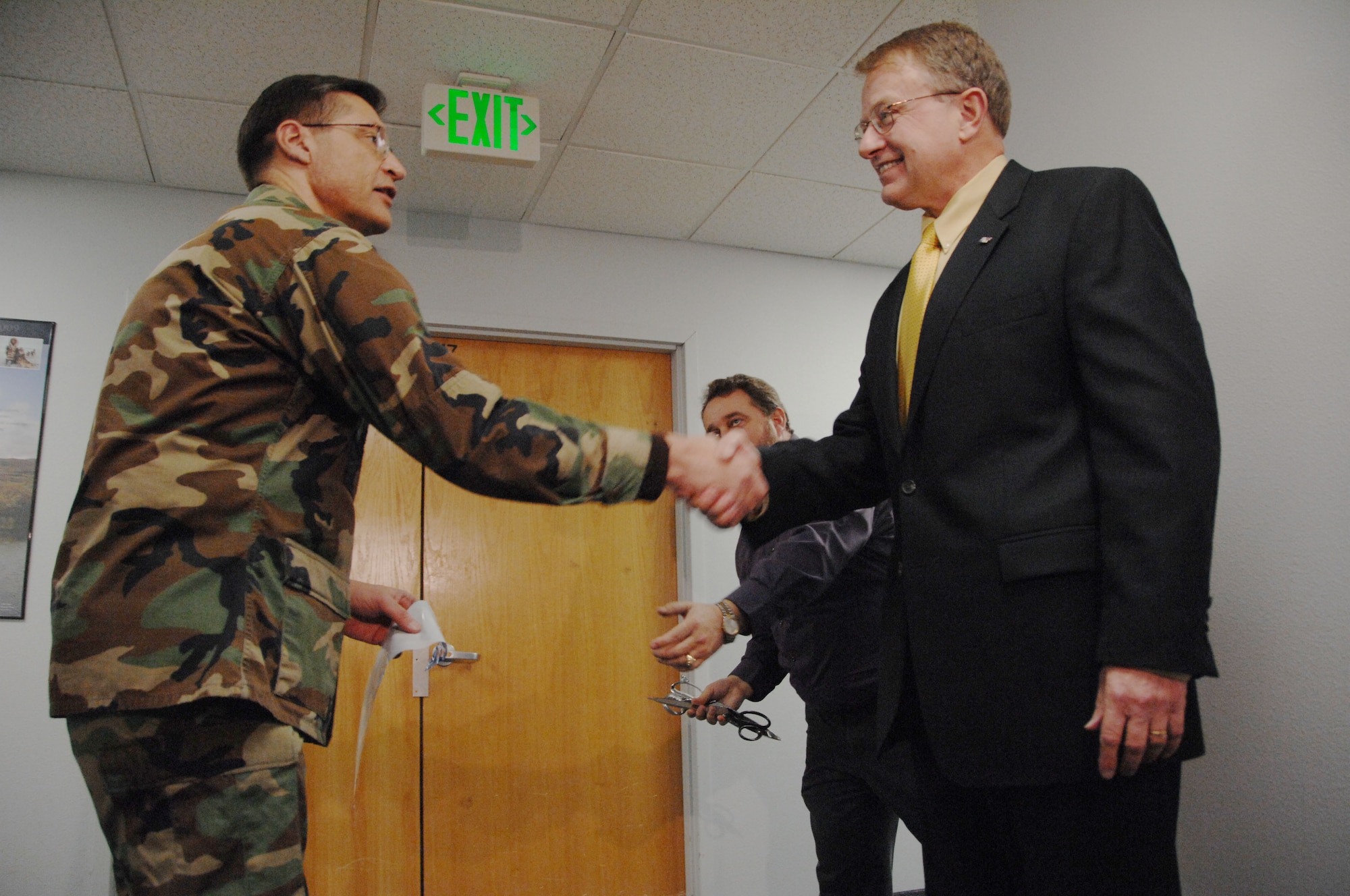 EIELSON AIR FORCE BASE, Alaska --Col. John Stutts, 354th Mission Support Group commander, and Steven Jones, Chancellor of the University of Alaska-Fairbanks, shake hands after cutting the ribbon leading into the new testing center Jan. 11, 2008 at the education office. The University of Alaska Fairbanks has recently established the National Testing Center at Eielson. The center will serve Airmen by providing College Level Examination Program (CLEP) and the Defense Activity for Non-Traditional Education Support (DANTES) tests. (U.S. Air Force photo by Airman 1st Class Christopher Griffin) 