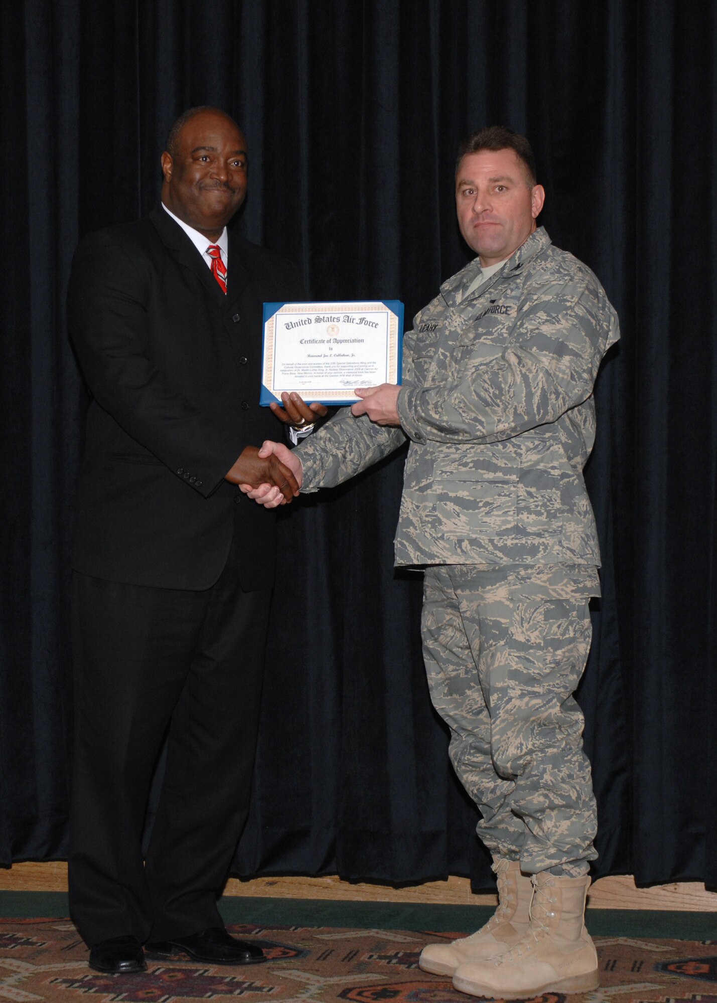 CANNON AIR FORCE BASE, N.M. - Rev. Joe Callahan Jr. is awarded a certificate of appreciation by Col. Timothy Leahy, 27th Special Operations Wing commander, at the Martin Luther King Jr. memorial breakfast Jan. 15. The breakfast, hosted by the Cultural Observance Committee, was held at the Landing in honor of Dr. King's birthday Jan. 17. (U.S. Air Force photo by Airman 1st Class James Bell)