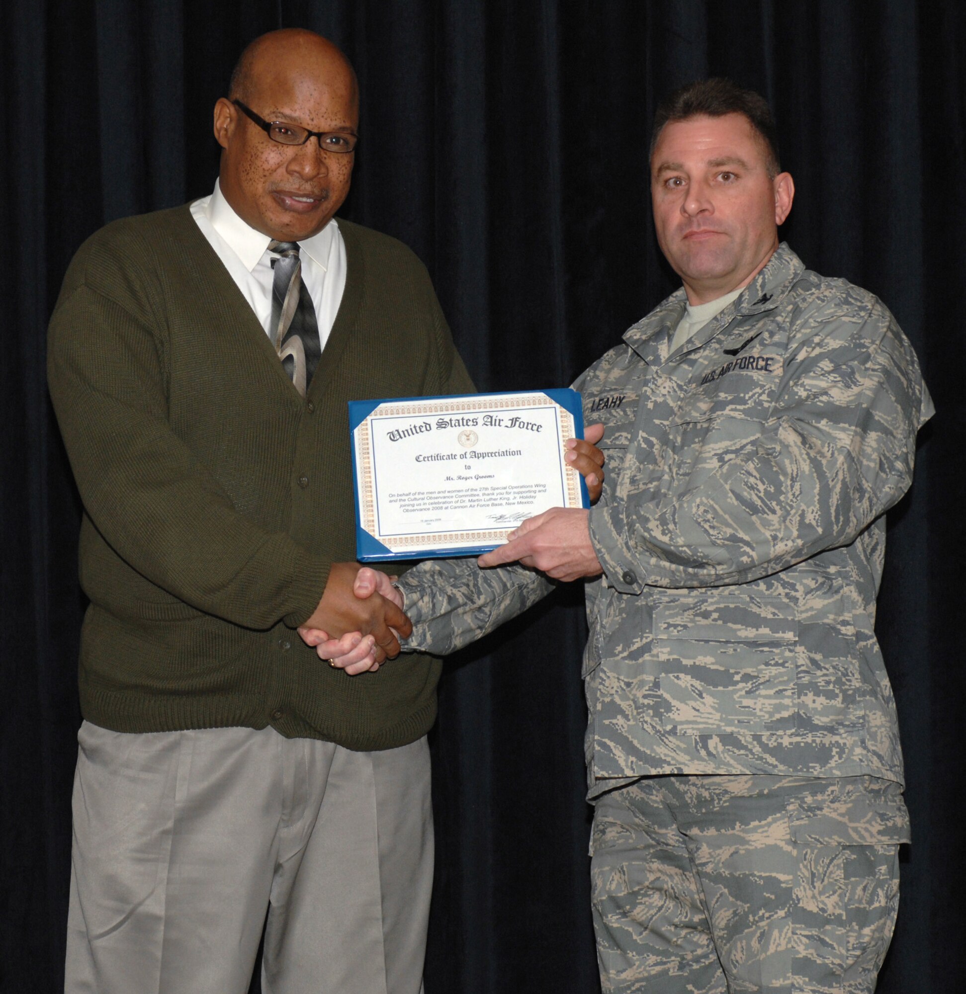 CANNON AIR FORCE BASE, N.M. - Roger Grooms, who retired from Cannon, is presented a certificate of appreciation by Col. Timothy Leahy, 27th Special Operations Wing commander at the Martin Luther King Jr. memorial breakfast Jan. 15. The breakfast, hosted by the Cultural Observance Committee, was held at the Landing in honor of Dr. King's birthday Jan. 17. (U.S. Air Force photo by Airman 1st Class James Bell)