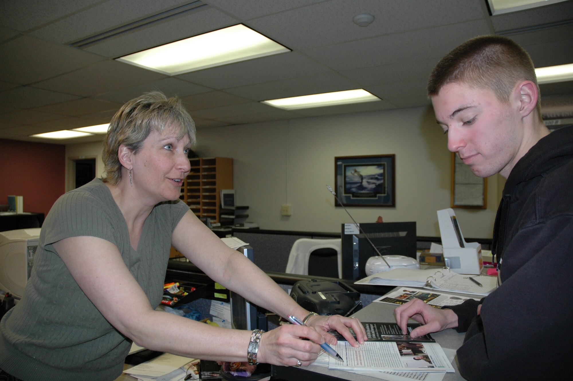 Ingrid Callahan, Education and Training Office flight chief, goes over material for the G.I. Bill and financial aid options with Airman 1st Class Shane McBride, 341st Missile Security Forces Squadron responce force leader. Information on scholarships and financial aid can be obtained through various Web sites and the Education and Training Office, 731-3531. (U.S Air Force photo/Airman 1st Class Emerald Ralston)