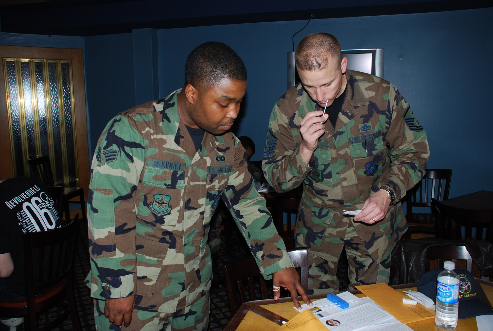 Senior Airman Marcel McKinney, 2nd Air Refueling Squadron, explains the tissue-collecting process to Master Sgt. Thomas Bathe, 305th Maintenance Squadron first sergeant, during the bone marrow drive here recently. Potential donors provided tissue samples (cheek swabs) in hopes of matching someone in the DoD bone marrow registry and/or the national registry. (U.S. Air Force photo/Airman 1st Class Rebekah Phy)  