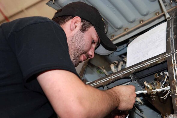 Chris Ridenour, L3 Communications contractor and Reservist with the 442nd Wing, Whiteman AFB, works on the Smart Multi-Functional Color Display modification of a Barksdale A-10. (U.S. Air Force photo/Tech. Sgt. Andre Menard)