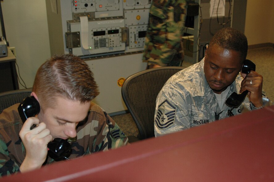 Senior Airman Aaron Blair and Master Sgt. John McClain, Barksdale Command Post, perform flight-following operations at the Barksdale Command Post Friday, Jan. 11. (U.S. Air Force photo/Master Sgt. Sherri Bohannon)