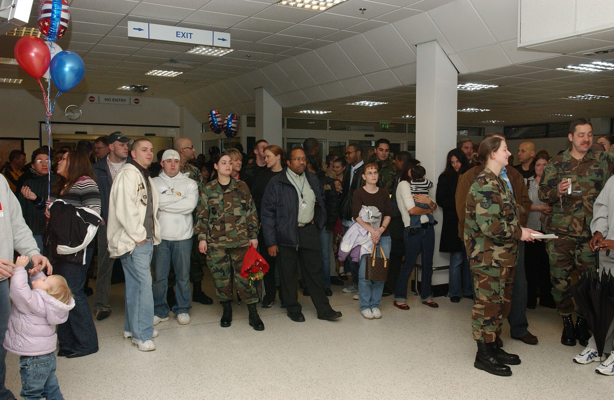 Commanders, first sergeants, squadron members, families and friends gather to be the first to welcome back their redeploying coworkers and loved ones Jan. 11, at the RAF Mildenhall passenger terminal.  (U.S. Air Force photo by Staff Sgt. Tyrona Pearsall)