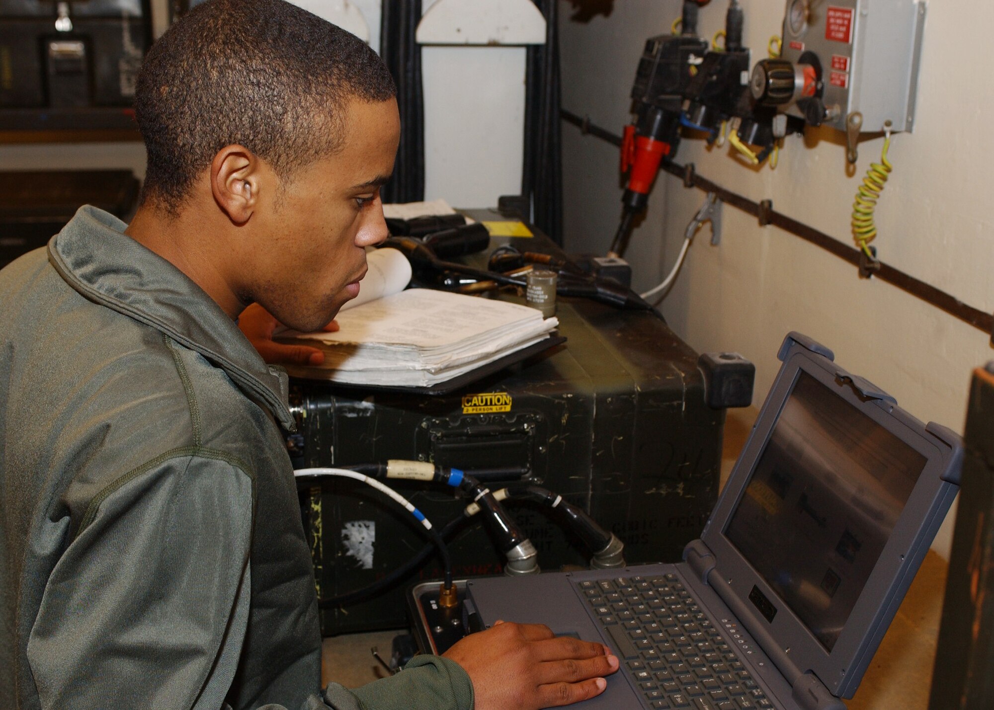 Senior Airman Kevin Johnson, 48 Munitions Squadron munitions systems specialist, performs a functional test of a guided bomb unit (GBU-15) at RAF Lakenheath, England Jan. 9. The test checks the functionality of all electrical systems inside the weapon and the video capability. The weapon is calibrated correctly to ensure it hits the proper target. (U.S. Air Force photo by Airman 1st Class Torri Ingalsbe)