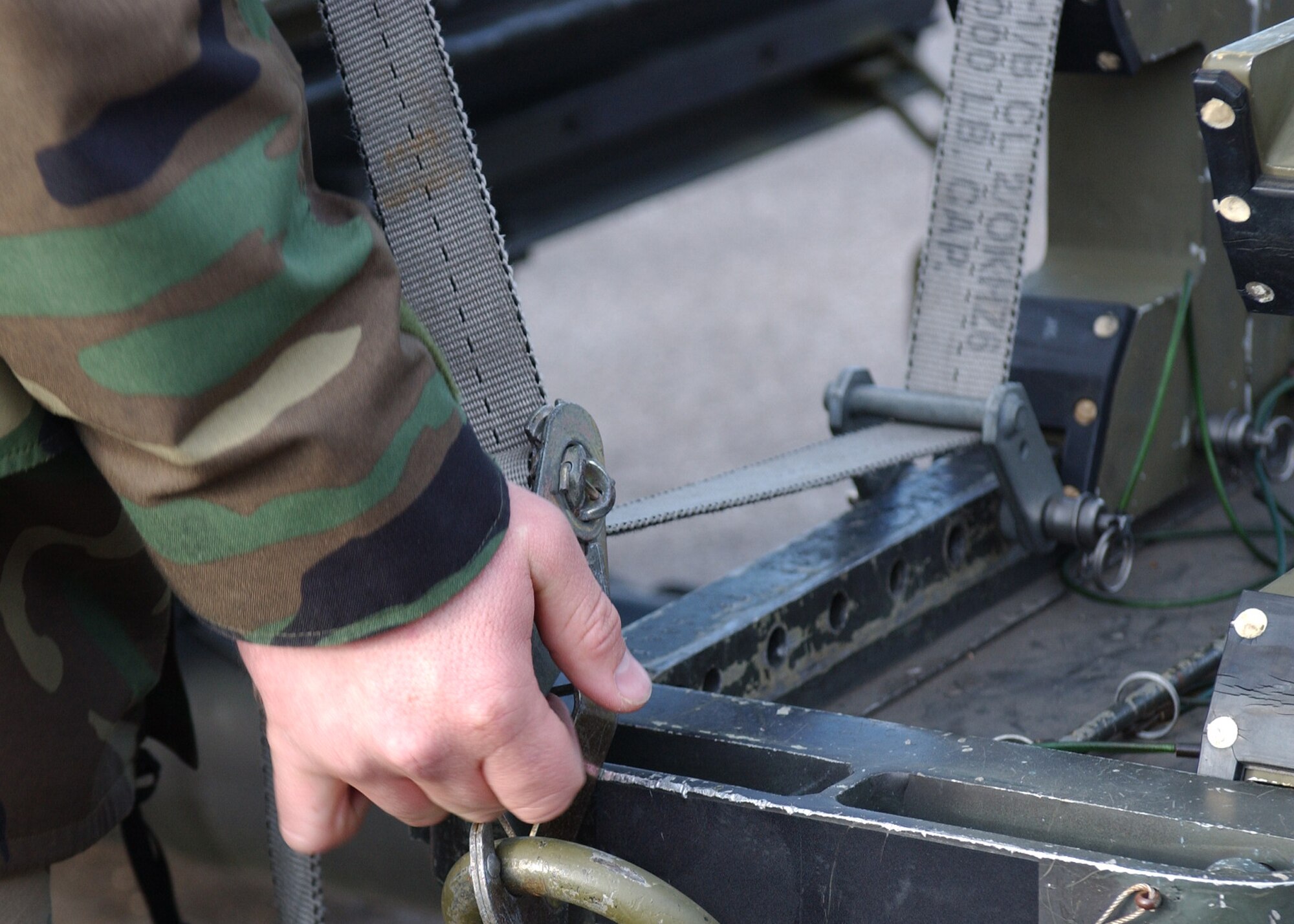 Airman 1st Class Tate Fackrell, 48th Munitions Squadron munitions systems specialist, checks the safety of the gear on the trailer transporting missiles to the flightline on RAF Lakenheath, England Jan. 9. After the missiles arrive on the flightline, armament loaders load the weapons onto the aircraft. (U.S. Air Force photo by Airman 1st Class Torri Ingalsbe)