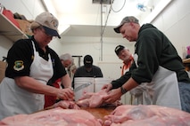MINOT AIR FORCE BASE, N.D. -- Colonel Joel Westa (right), 5th Bomb Wing commander, and Chief Master Sergeant Susan Baker, 5th Mission Support Group superintendent, prepare ducks at Bloms Locker for the Sportsmen's Feed, which was held January 13. (U.S. Air Force photo by SrA Christopher Boitz)