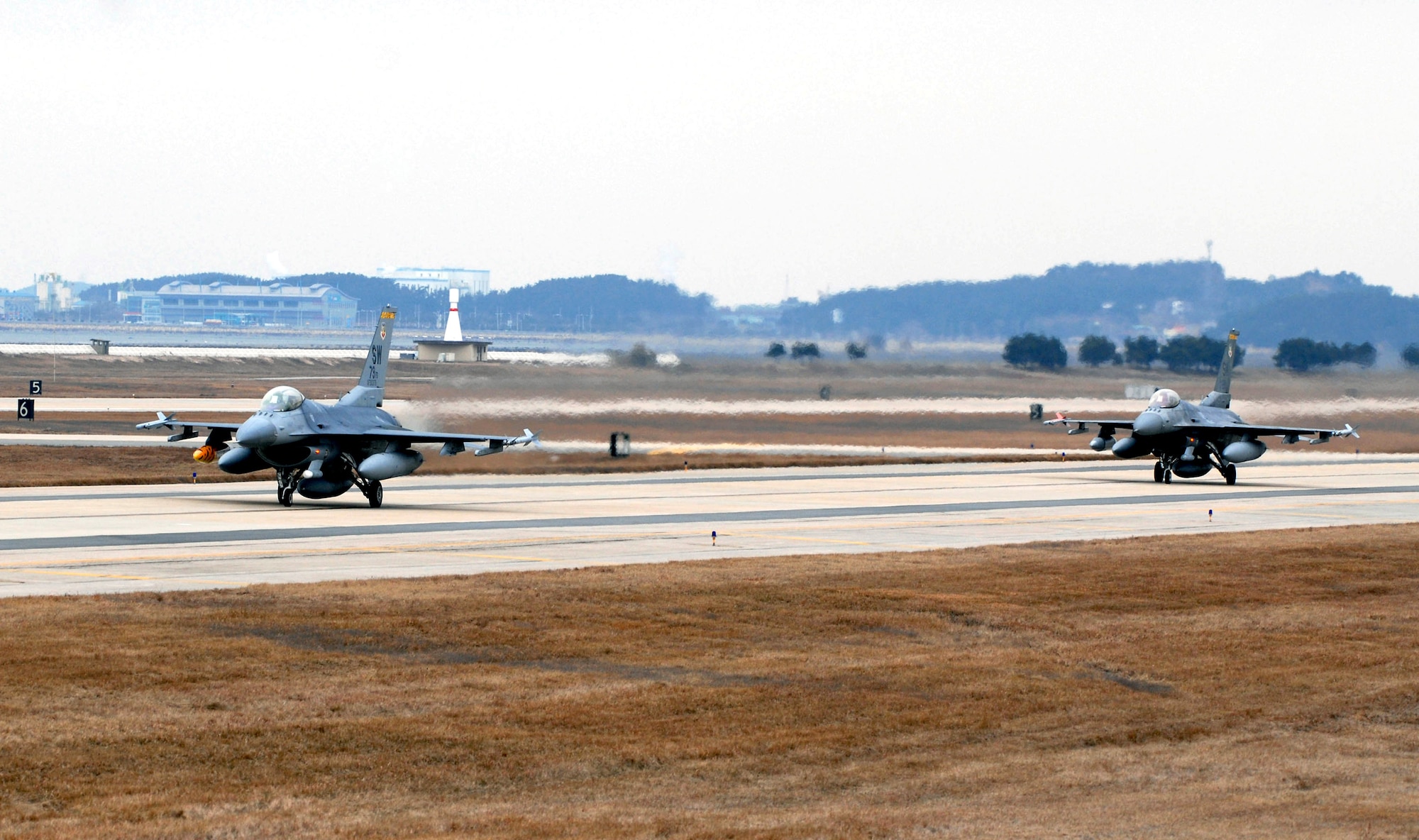 F-16 Fighting Falcons taxi on the runway Jan. 15 at Kunsan Air Base, South Korea. More than 300 Airmen and several aircraft from the 79th Fighter Squadron from Shaw Air Force Base, S.C., are in South Korea as the squadron's air and space expeditionary force deployment to help maintain peace and stability in the Pacific region. (U.S. Air Force photo/Senior Airman Steven R. Doty)
