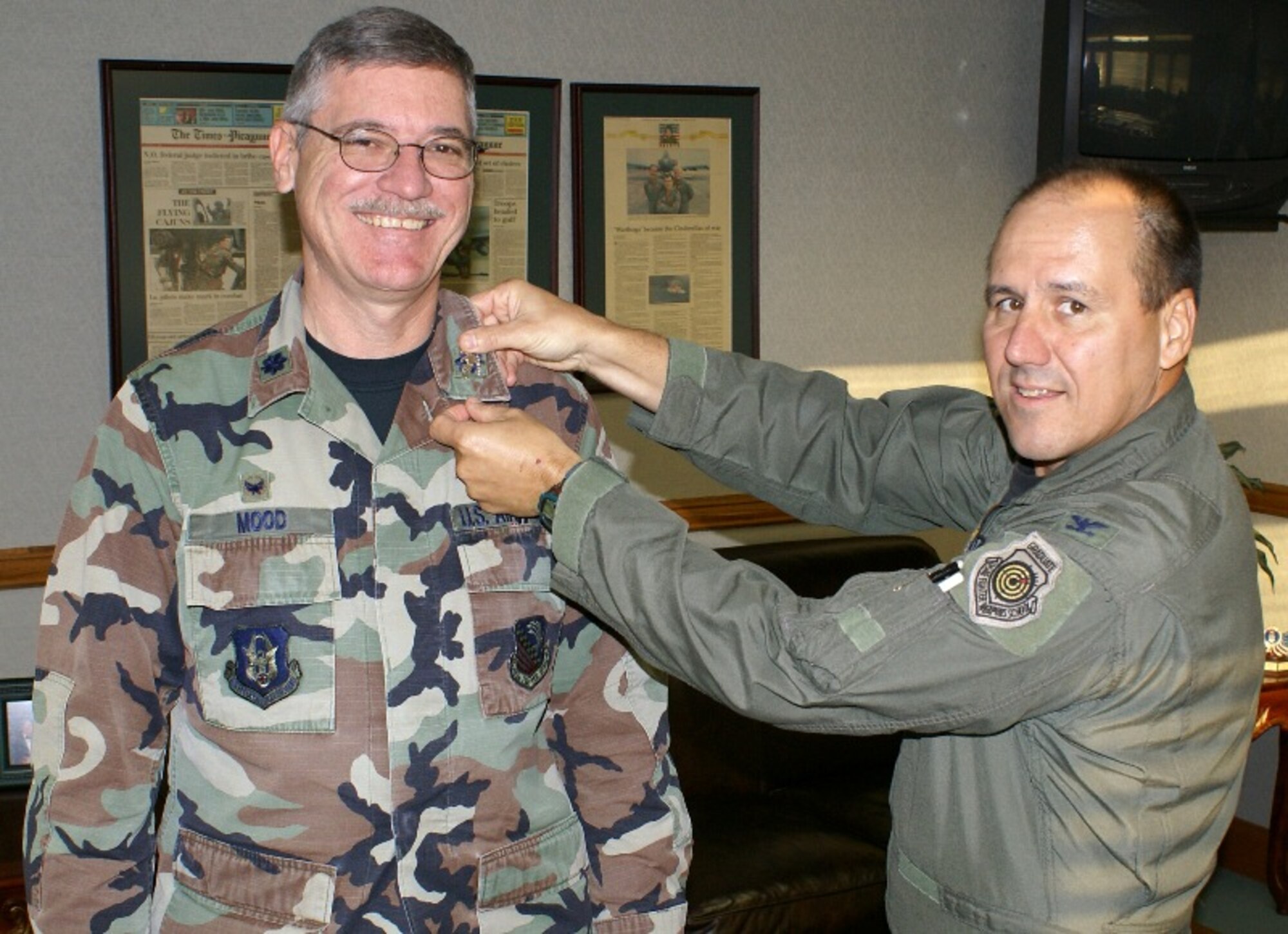 Col. Charles Mood, 482nd Logistics Readiness Squadron commander, has the rank of colonel "pinned" on by Col. Randall Falcon, 482nd Fighter Wing commander, on Jan. 15. The new colonel was asked to drop by the wing commander’s office for a pressing meeting and was surprised with an informal ceremony. Colonel Mood has accepted the position of commander of 419th Mission Support Group, Hill Air Force Base, Utah. (U.S. Air Force photo/Senior Airman Erik Hofmeyer)