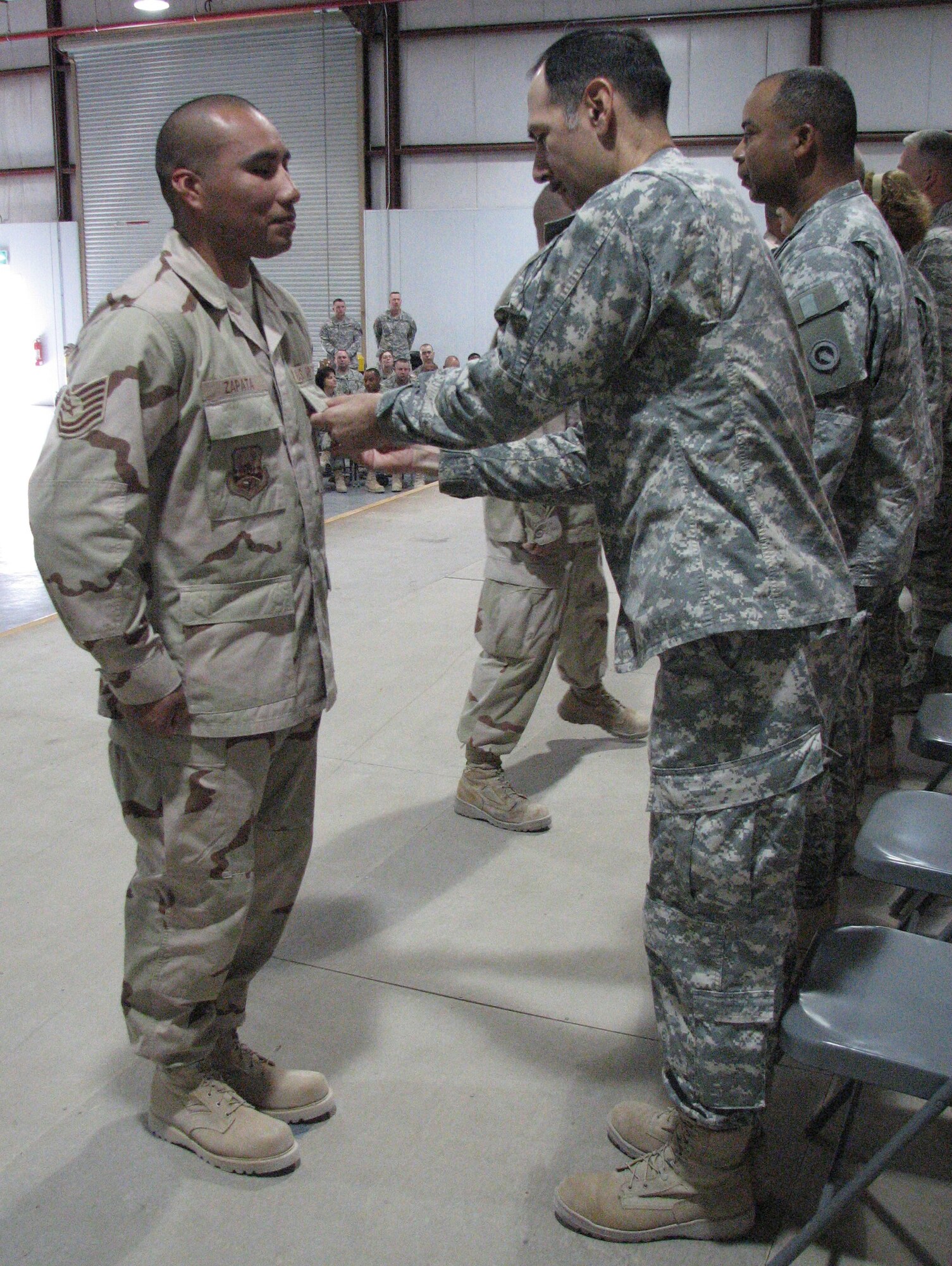 Tech. Sgt. Lorenzo Zapata, deployed from the 435th Vehicle Readiness Squadron, receives a Bronze Star medal at his deployed location in southwest Asia.   
