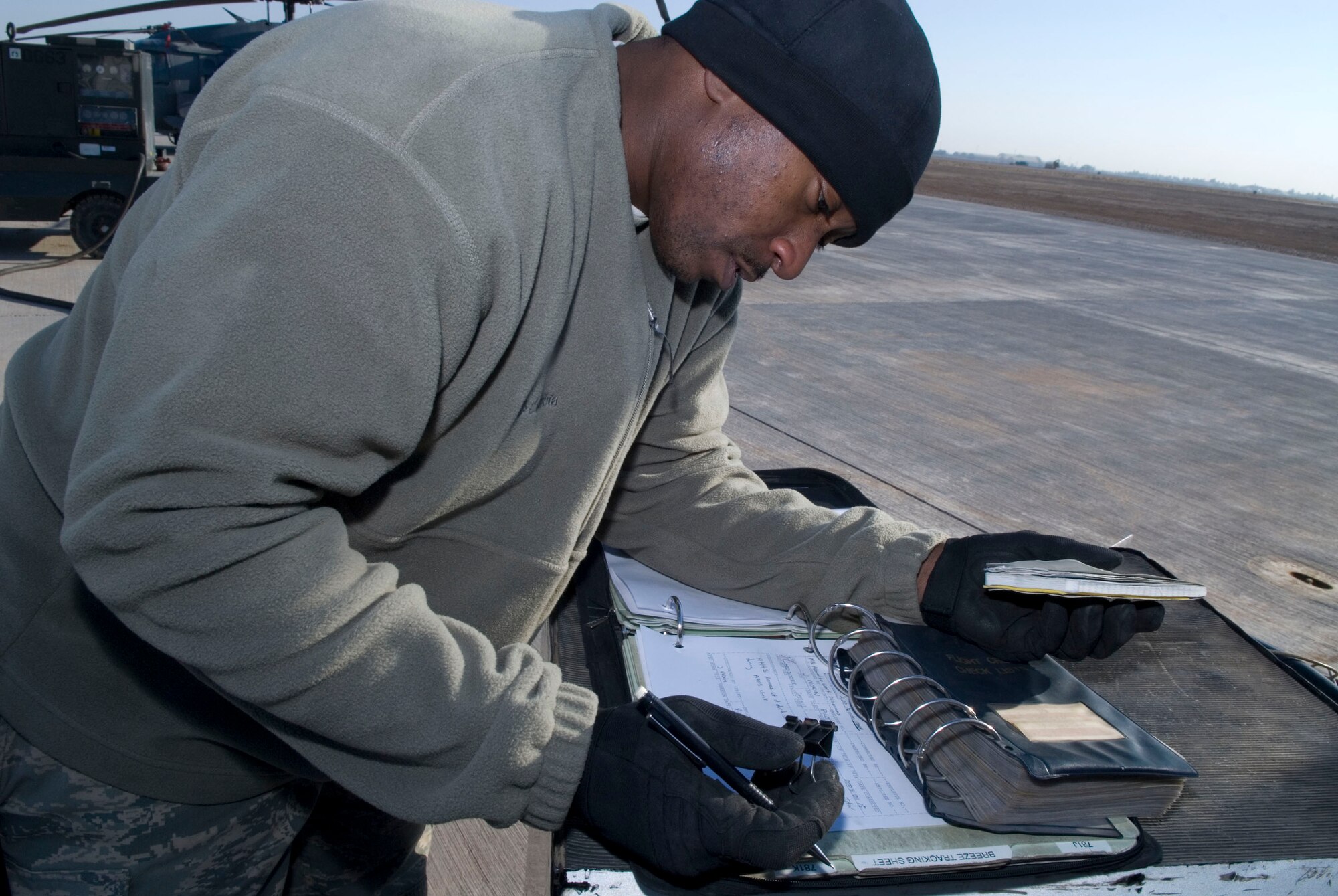 BALAD AIR BASE, Iraq -- Staff Sgt. Elijah Neal, a 64th Expeditionary Helicopter Maintenance Unit instrumentation and flight control systems specialist, documents maintenance on a HH-60 Pavehawk helicopter here, Jan. 15. Completed maintenance is documented to keep an up to date record of work performed. Sergeant Neal is deployed from Nellis Air Force Base, Nev. (U.S. Air Force photo/Staff Sgt. Joshua Garcia)