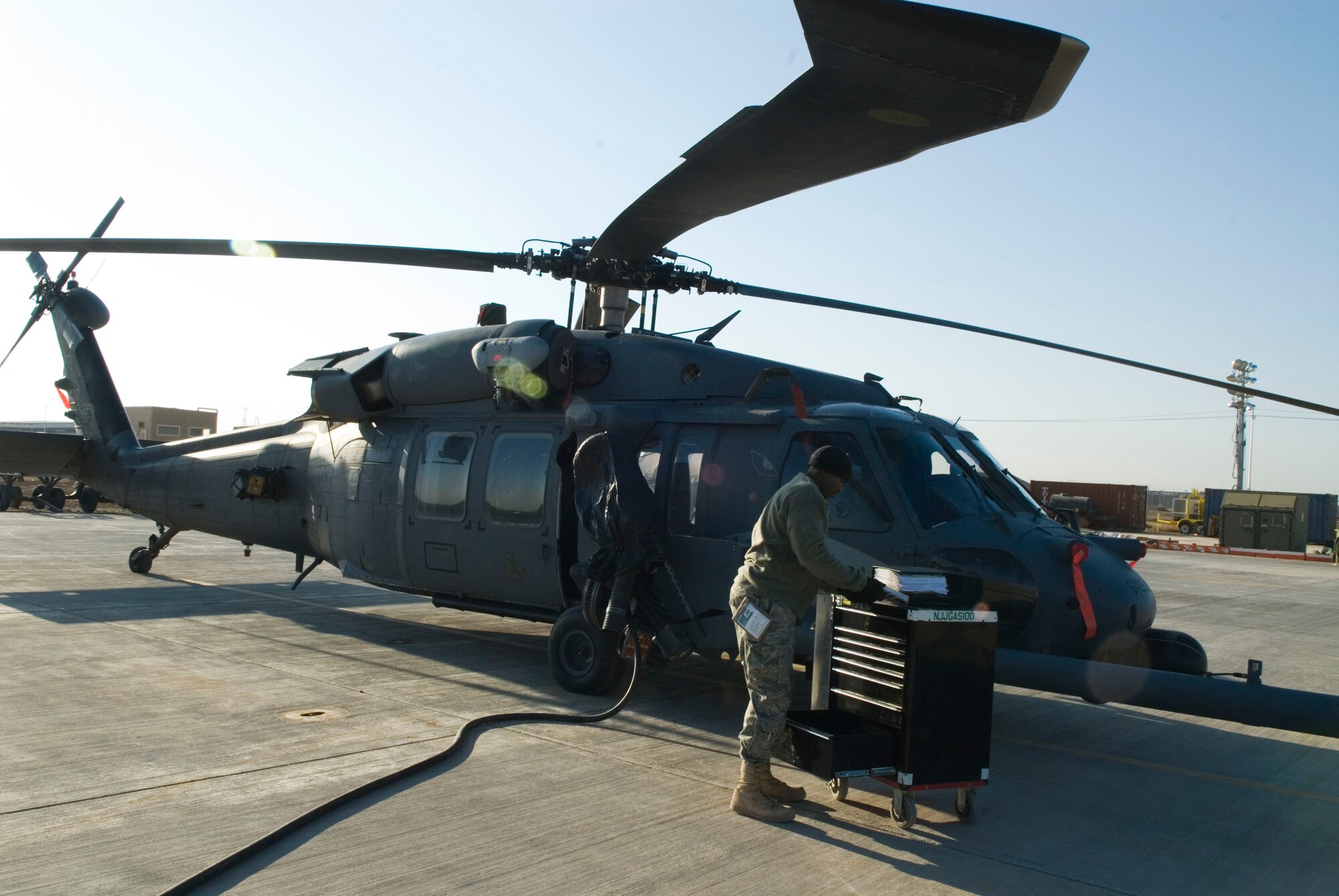 BALAD AIR BASE, Iraq -- Staff Sgt. Elijah Neal, a 64th Expeditionary Helicopter Maintenance Unit instrumentation and flight control systems specialist, stores his tools after troubleshooting the Altitude Hover Hold Stabilization system for an HH-60 Pavehawk helicopter here, Jan. 15. All tools are accounted for and returned to the tool tent after maintenance is performed. Sergeant Neal is deployed from Nellis Air Force Base, Nev. (U.S. Air Force photo/Staff Sgt. Joshua Garcia)