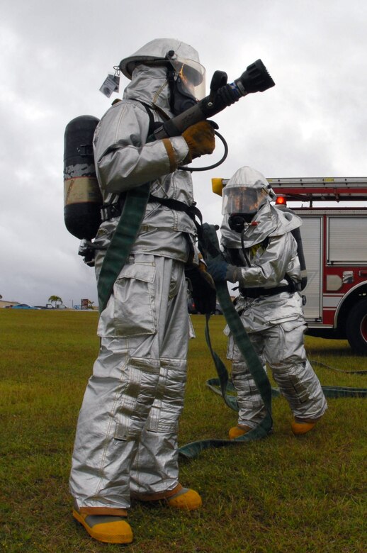 Airmen 1st Class Mark Maslawski and Hector Garcia prepare to decontaminate potential victims of a suspicious package during a Disease Containment Exercise Jan. 15.  The Airmen are fire apprentices from the 36th Civil Engineer Squadron. (U.S. Air Force photo/Airman 1st Class Jonathan Hart)