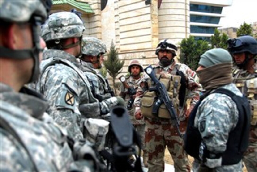 U.S. Army soldiers with 4th Infantry Regiment speak with a sergeant before a mission in Monsour, Iraq, Jan. 9, 2008. 
