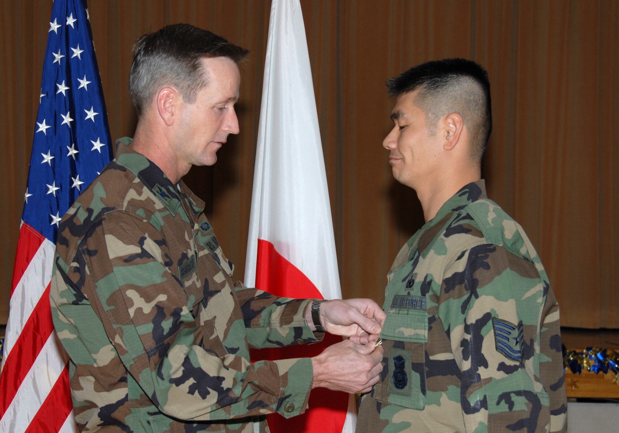 MISAWA AIR BASE, Japan -- Tech. Sgt. Max Van Ausdal, 35th Security Forces Squadron, receives the Bronze Star from Col. T.J. O'Shaughnessy, 35th Fighter Wing commander, here Dec. 18, 2007.  Sergeant Van Ausdal received the medal for his contributions while deployed in support of Operation Iraqi Freedom. (U.S. Air Force photo by Senior Airman Laura R. McFarlane)