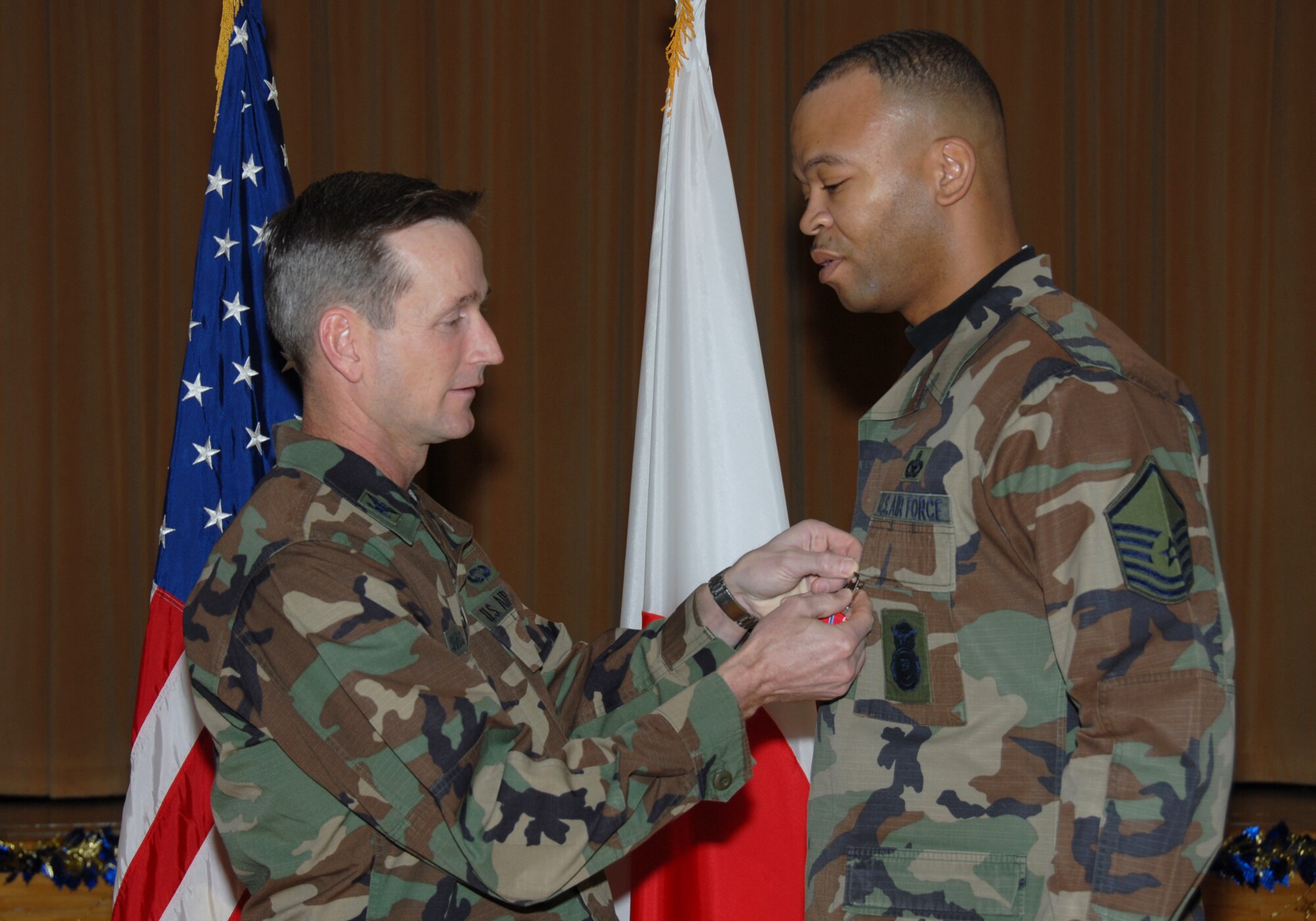 MISAWA AIR BASE, Japan -- Master Sgt. Robert Briggs, 35th Security Forces Squadron, receives the Bronze Star from Col. T.J. O'Shaughnessy, 35th Fighter Wing commander, here Dec. 18, 2007.  Sergeant Briggs received the medal for his contributions while deployed in support of Operation Iraqi Freedom.  (U.S. Air Force photo by Senior Airman Laura R. McFarlane)