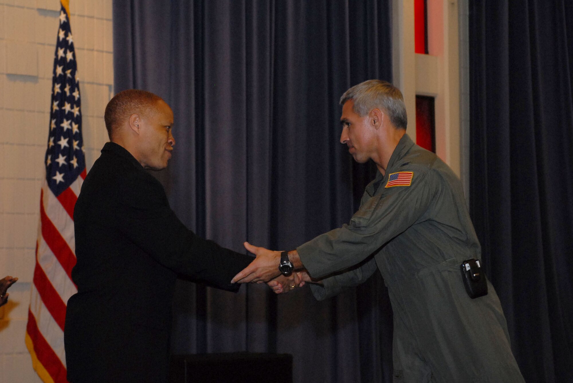 Col. JJ Torres, 15th Airlift Wing commander presents Elder Raymond Black III, Senior Pastor of Living the Word Ministries, with a gift on behalf of the African American Heritage Association. Photo by Oscar Hernandez