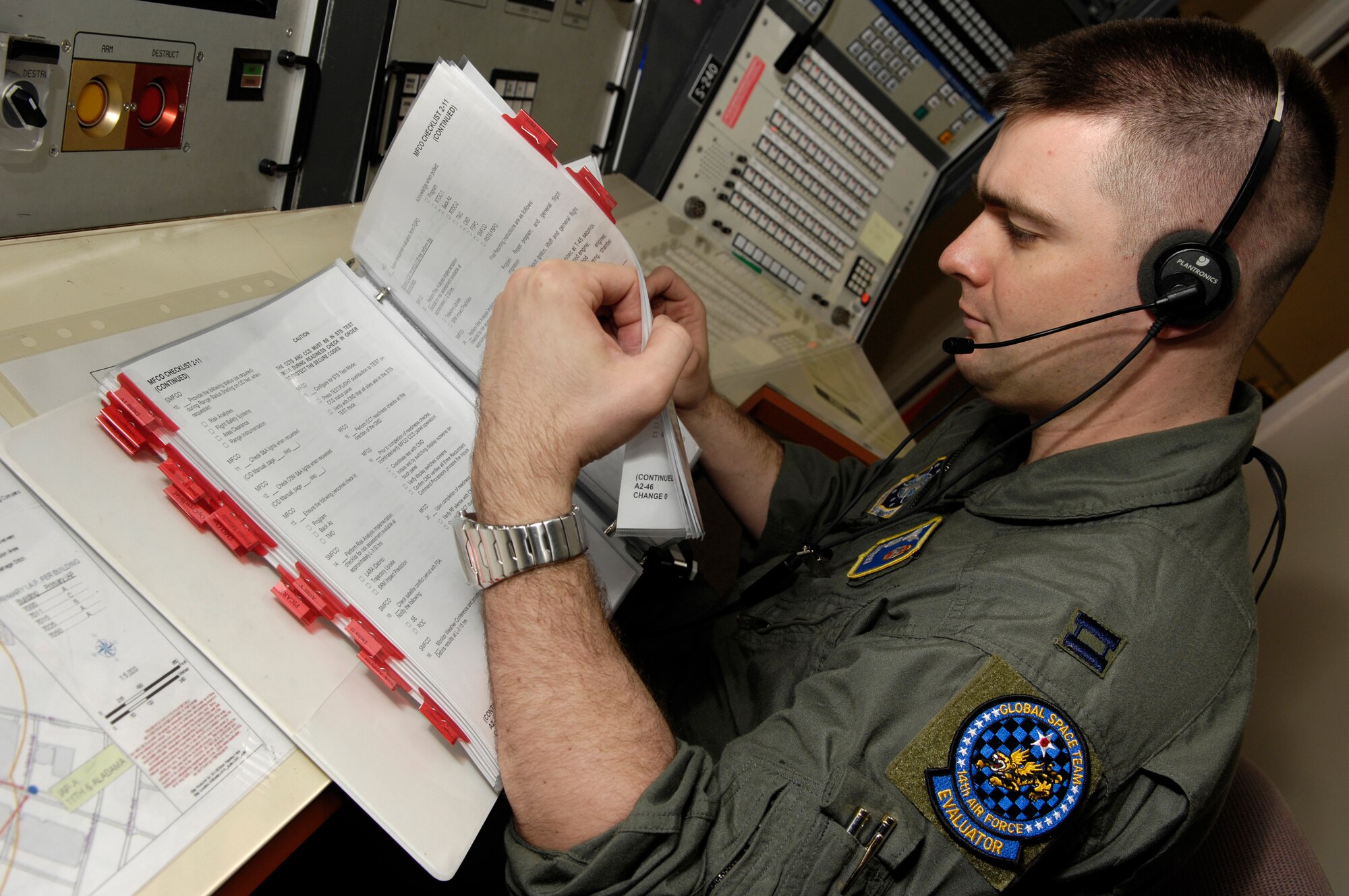 VANDENBERG AIR FORCE BASE, Calif. -- Capt. Jon Krepsky, a 30th Operations Support Squadron mission control flight officer, flips through the pages of a range operations manual during a training scenario on Jan. 14. Mission flight control officers are responsible for all flight control activities including launch preparation, pre-flight test and evaluations and flight control from liftoff to end of mission. The scenario is the deciding factor on who is selected to be on the elite 30th Space Wing Guardian Challenge Team.  Air Force Space Command hails GC as the only space war fighter competition in the Air Force. The competition pits the "best of the best" space war fighters against each other, determining the top space wing teams in the Air Force. The event captures the essence of competition through rigorous evaluation and increases the overall capabilities of operations teams to perform their missions. (U.S. Air Force photo/Airman 1st Class Christian Thomas)  
